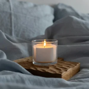 A candle is lit on top of a piece of bread.